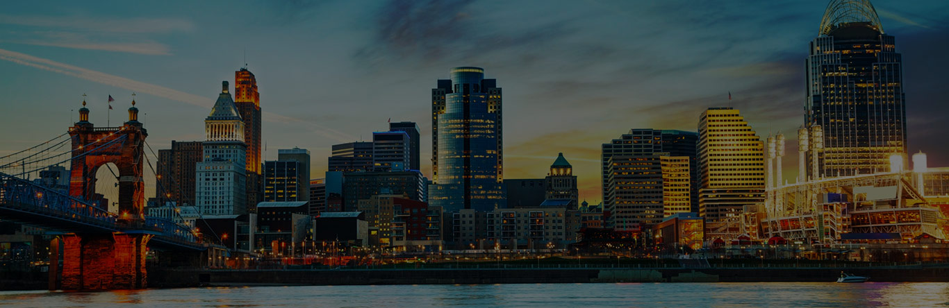 Residential main image city skyline behind river at dusk